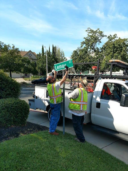 antioch public works team fixing street sign